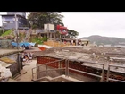 Slow tracking shot of favela community before the start of a soccer game