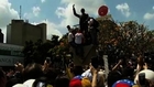 Violent protests sweep Caracas, opposition leader surrenders