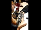 The tattoo artist Jc Lyons Sheitan Tenet makes a tattoo with a biomechanical arm